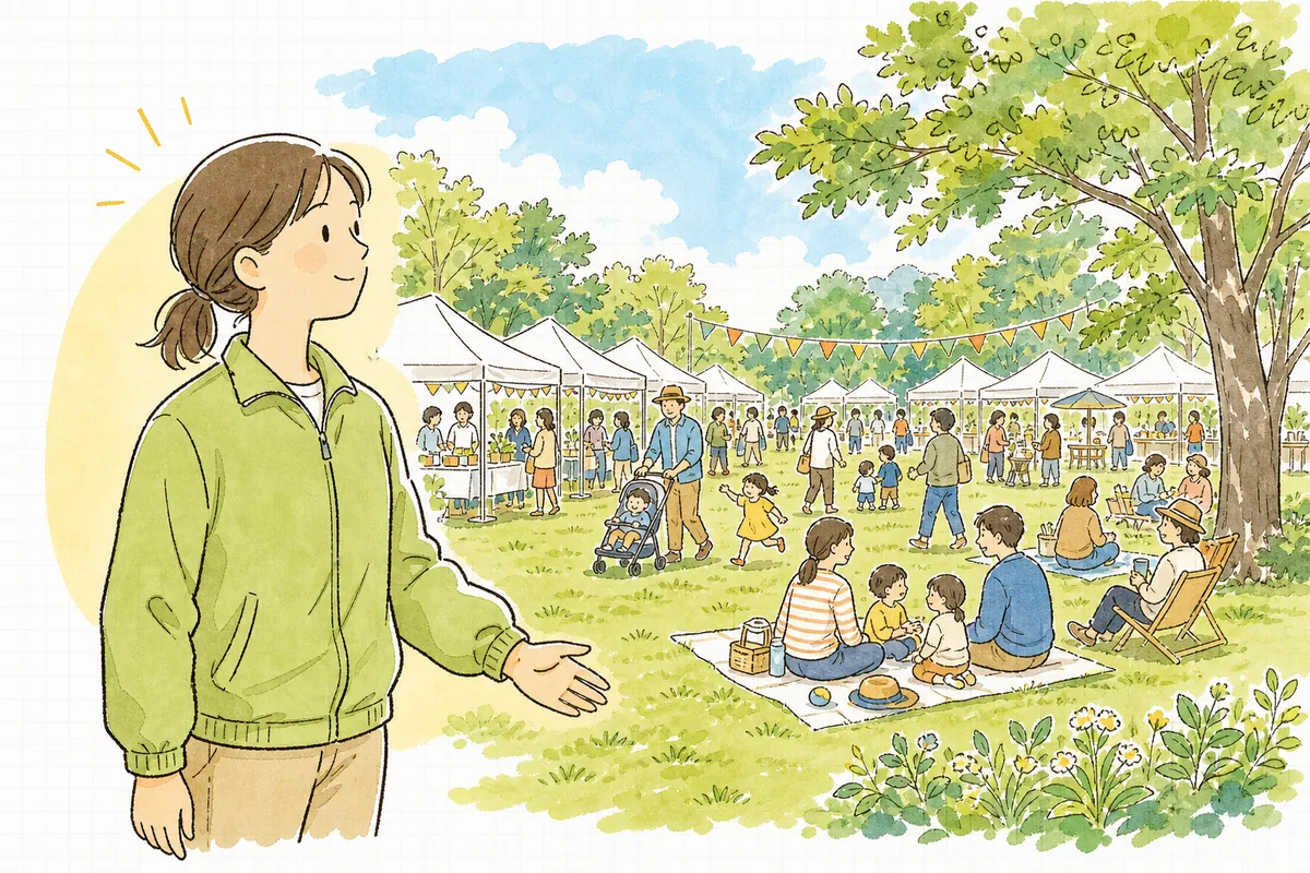 許可を得て開催された公園のイベントで、芝生の広場に集まった来場者と笑顔で立つ運営スタッフの穏やかな情景
